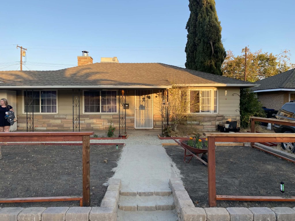 Ranch-style home exterior at golden hour after front-yard work
